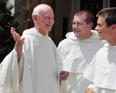 Father Kenneth Letoile, O.P. talking with two novices, Brother Ezra Fegley and Brother Philip Nolan.