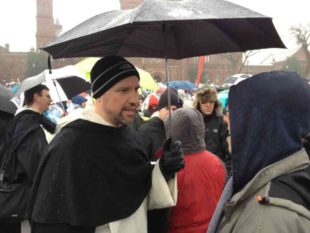 Fr. Benedict Croell, O.P., under an umbrella at the March for Life.