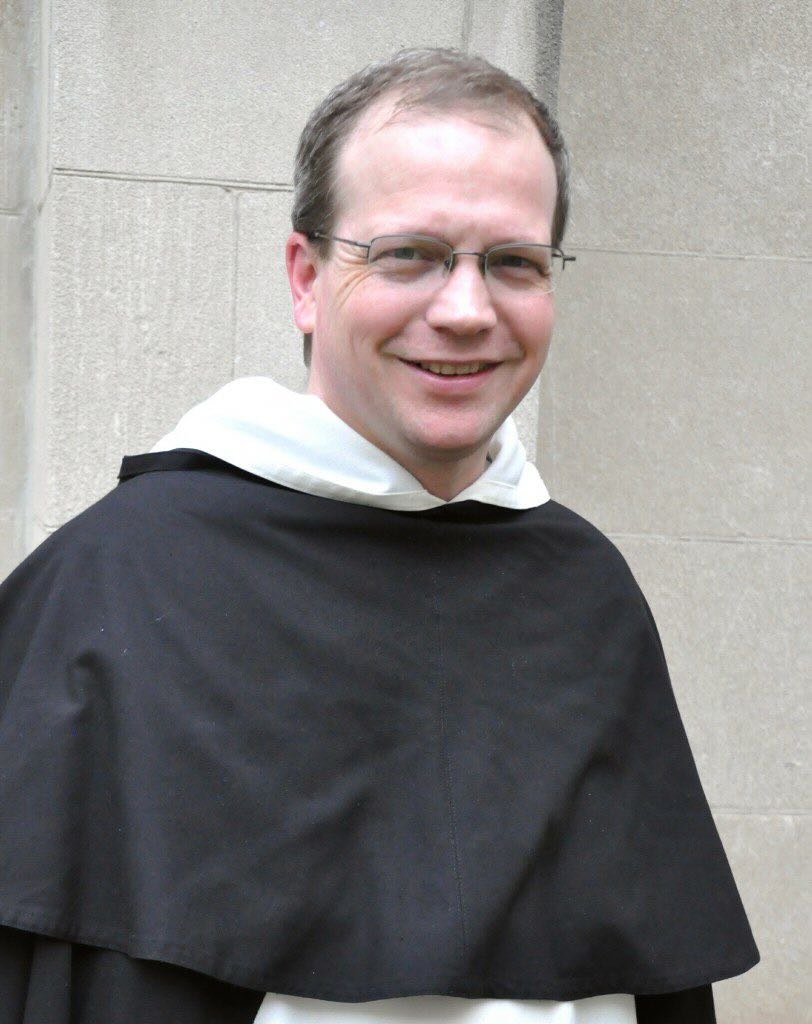 Headshot of Fr. Thomas Joseph White, O.P. in front of a greay wall Photo: Fr. Lawrence Lew, O.P.