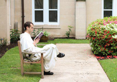Br. Bonaventure Chapman, O.P. reads in the Cloister Garden at the Dominican House of Studies.