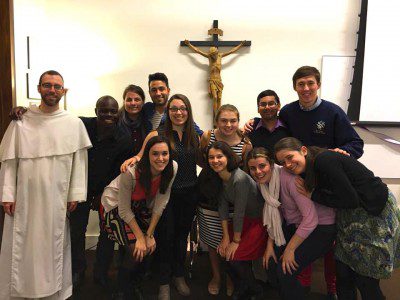 Fr. Sebastian White, O.P., with students at the NYU Catholic Center.