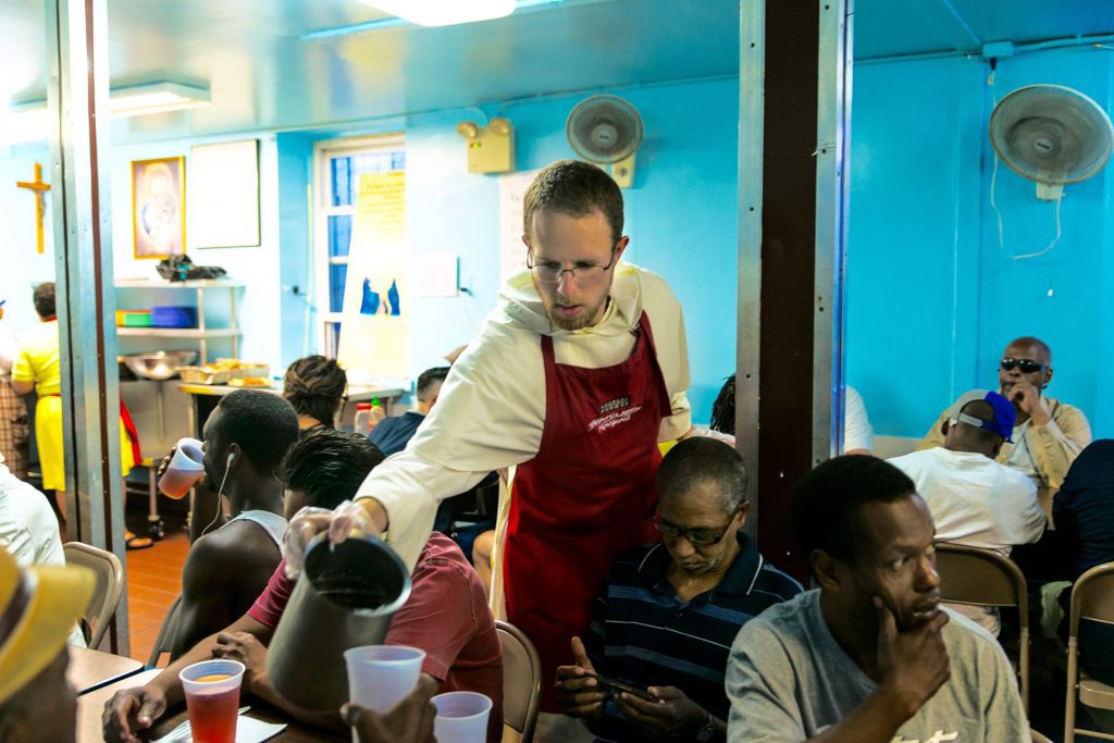 Dominican Friar Serving people drinks.