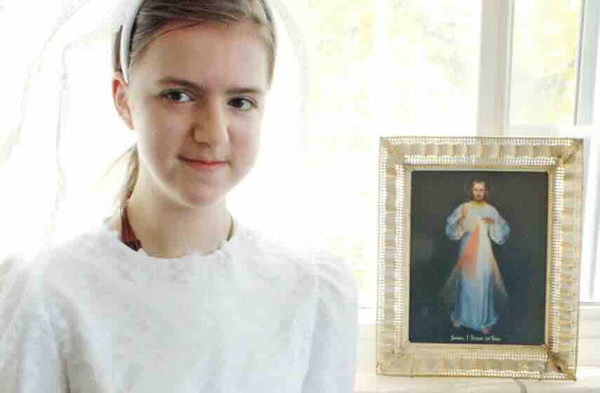 Lucy next to image of divine mercy