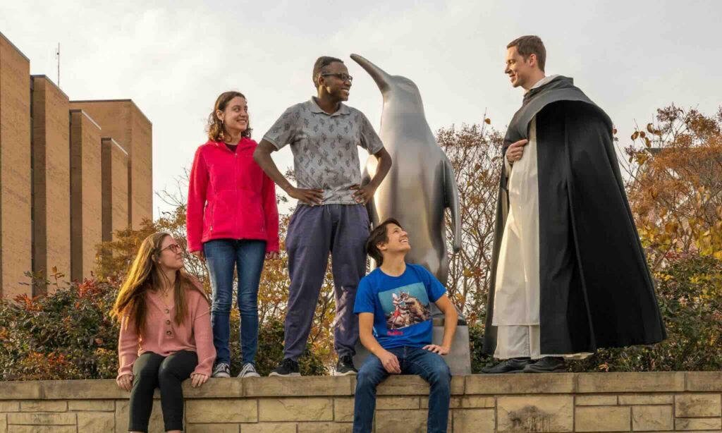 Fr. Norbert Keliher with students on the Youngstown State Campus