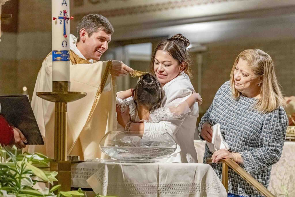 Fr. Frassati Davis, O.P., baptizes a new parishioner at St. Dominic’s Parish in Youngstown, Ohio.