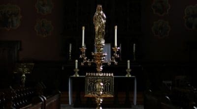 An altar with candles in a dark church